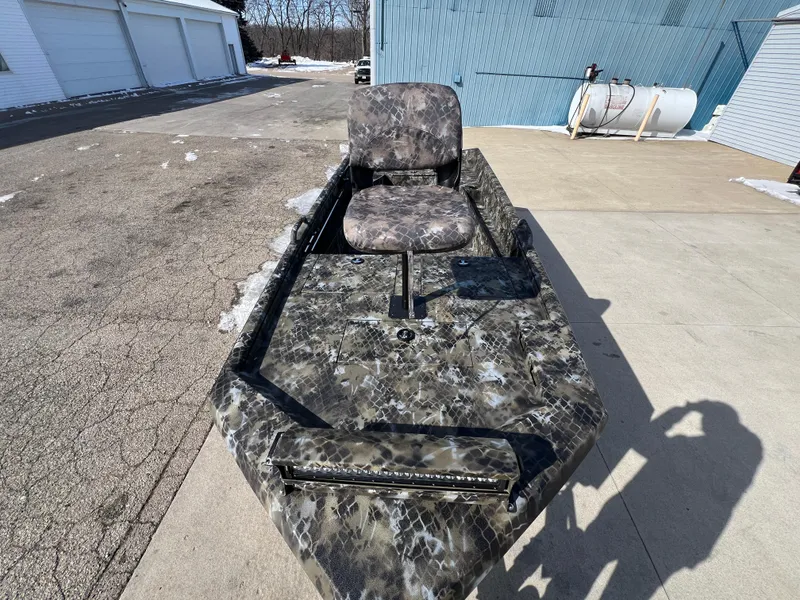 Slide: The Image of 2025 Excel Eclipse boat with camouflage design, featuring a single seat, parked outdoors. - 7