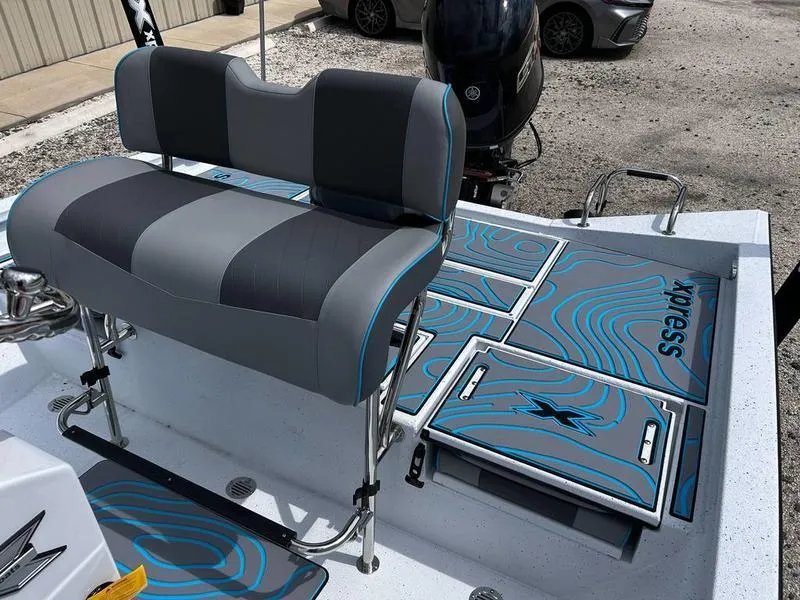 Slide: The Image of 2025 Xpress H20B boat interior with stylish seating and storage compartments. - 10