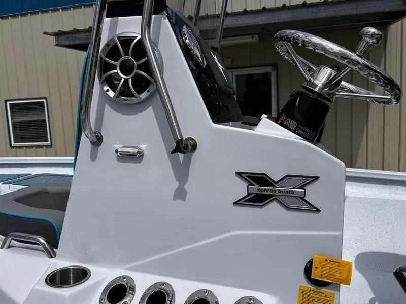 Slide: The Image of 2025 Xpress H20B boat console with steering wheel and speaker detail. - 12