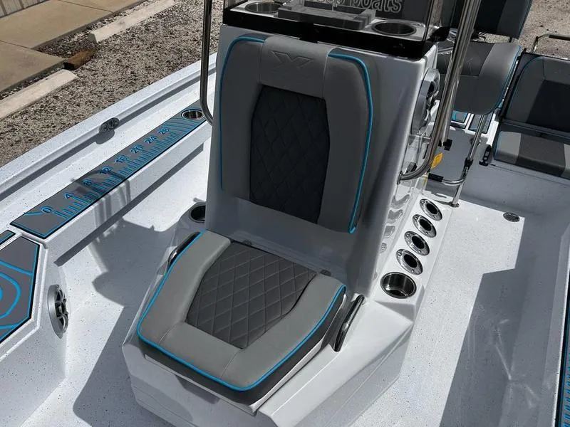 Slide: The Image of 2025 Xpress H20B boat seat with gray and blue accents, featuring cup holders and diamond stitching. - 17