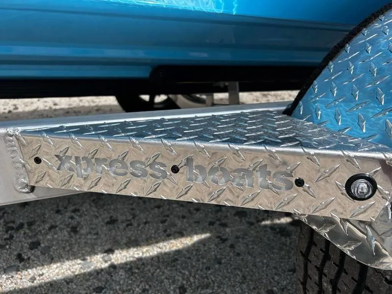 Slide: The Image of 2025 Xpress H20B boat trailer with diamond plate design and visible branding. - 22
