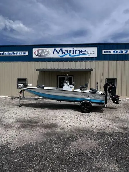 Slide: The Image of 2025 Xpress H20B boat on trailer outside L&M Marine LLC building. - 23