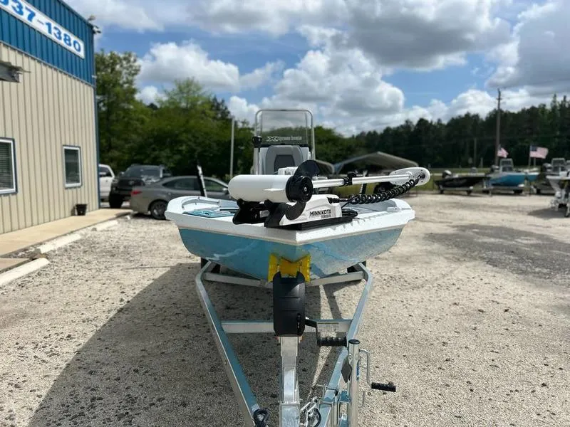 Slide: The Image of 2025 Xpress H20B boat on trailer, parked outdoors under a cloudy sky. - 4