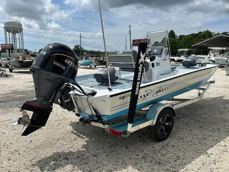 Slide: The Image of 2025 Xpress H20B boat with Yamaha engine on a trailer, parked outdoors. - 6