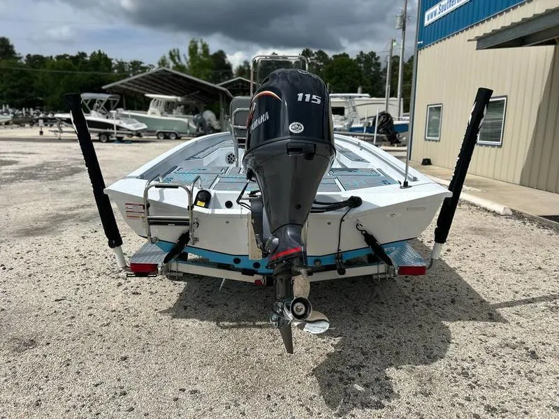 Slide: The Image of 2025 Xpress H20B boat with Yamaha 115 engine, parked outdoors near a building. - 7
