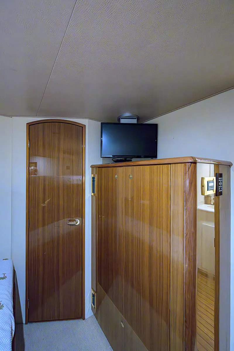 Slide: The Image of Interior of 2007 Viking 68 Convertible yacht with wooden cabinetry and mounted TV. - 22