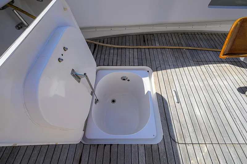 Slide: The Image of Open hatch on 2007 Viking 68 Convertible yacht deck, revealing storage compartment. - 34