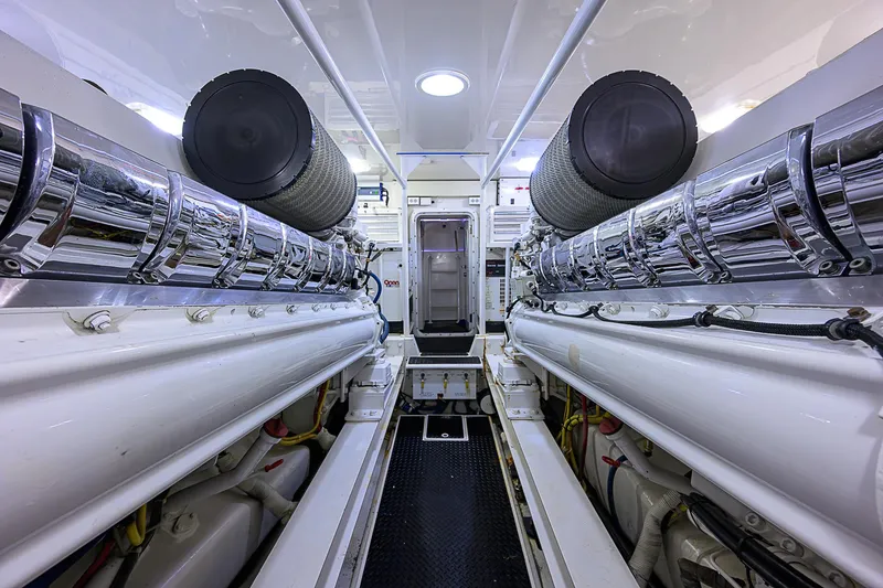 Slide: The Image of Engine room of a 2007 Viking 68 Convertible yacht, showcasing sleek, polished machinery. - 36