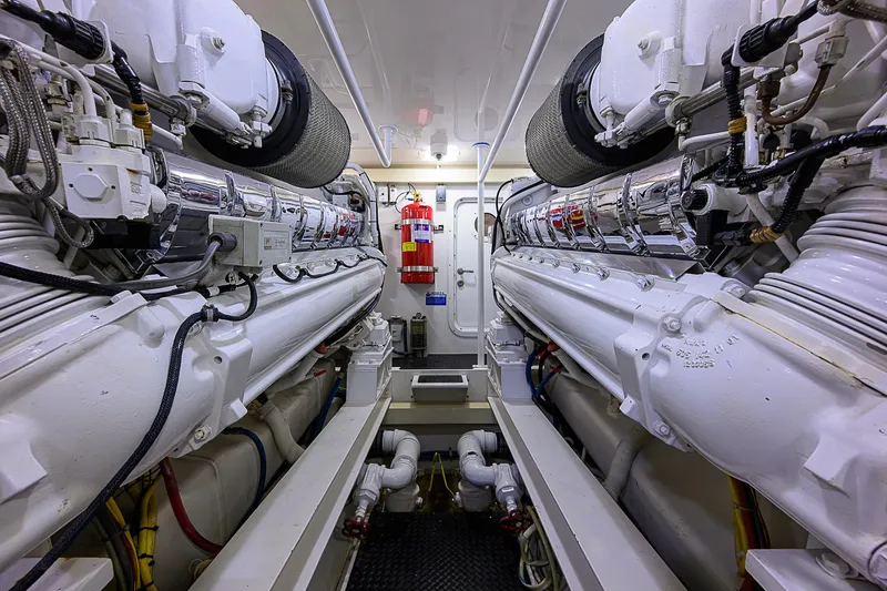 Slide: The Image of Engine room of a 2007 Viking 68 Convertible yacht, featuring dual engines and fire safety equipment. - 47