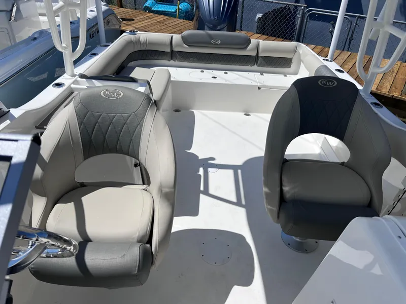 Slide: The Image of 2025 Key West 239 DFS boat interior with cushioned seating and steering wheel. - 18