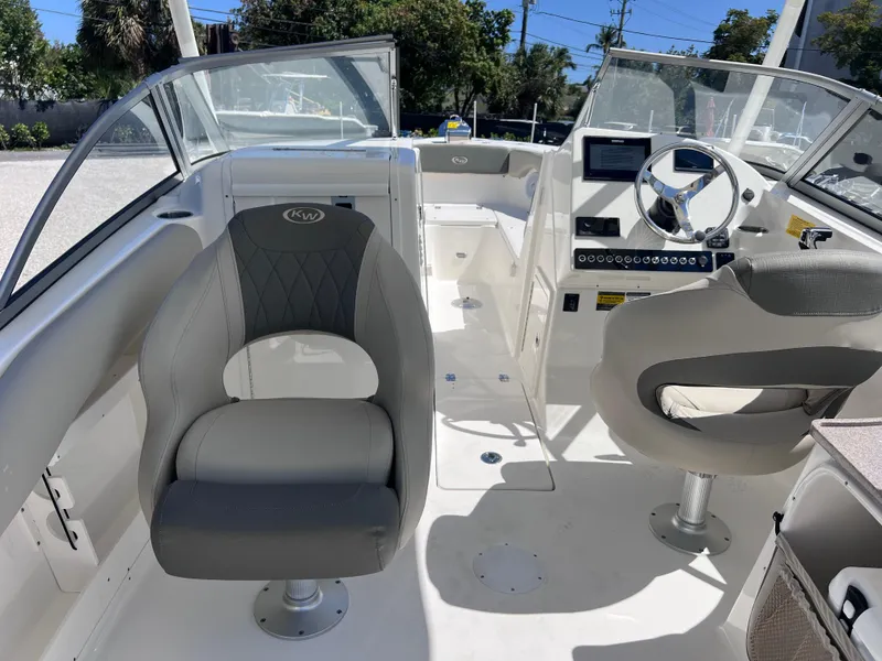 Slide: The Image of 2025 Key West 239 DFS boat interior with modern seating and dashboard. - 19