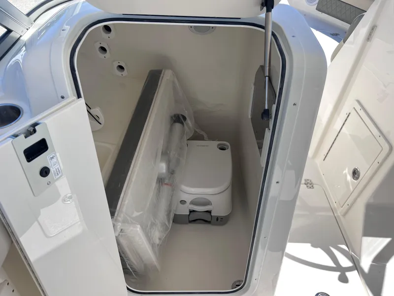 Slide: The Image of 2025 Key West 239 DFS boat interior with compact marine toilet. - 21