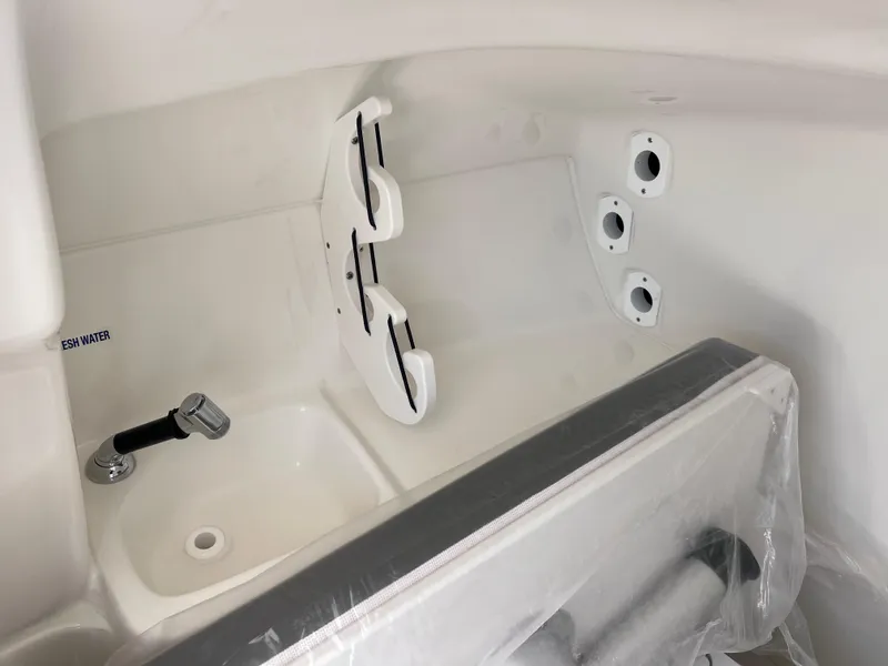 Slide: The Image of 2025 Key West 239 DFS boat interior with sink and storage compartments. - 22