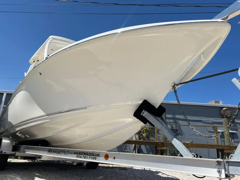 Slide: The Image of 2025 Key West 239 DFS boat on trailer under clear blue sky. - 3