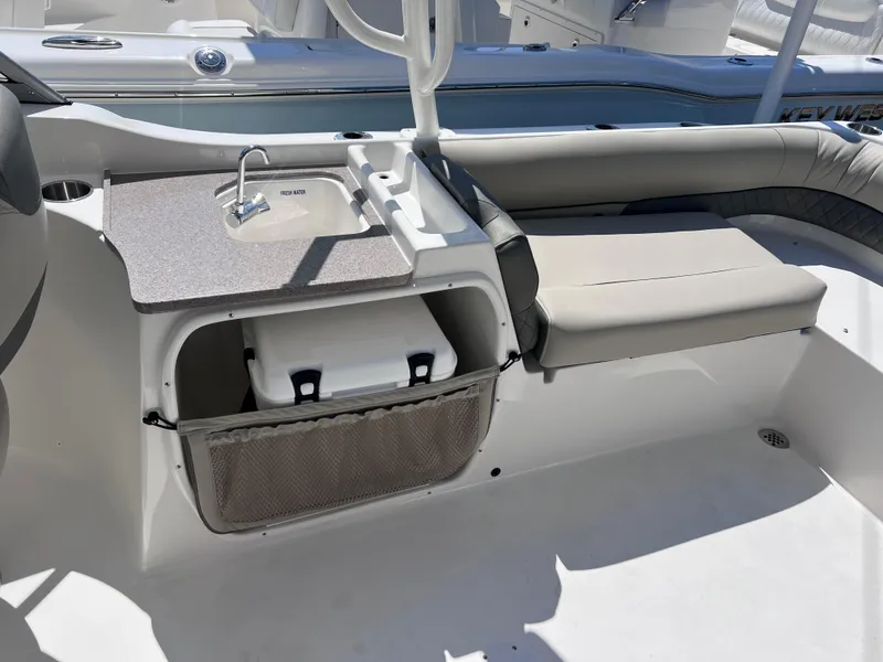 Slide: The Image of 2025 Key West 239 DFS boat interior with sink, seating, and storage area. - 31