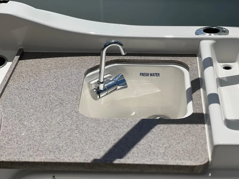Slide: The Image of Freshwater sink on 2025 Key West 239 DFS boat, featuring a sleek faucet and countertop. - 32