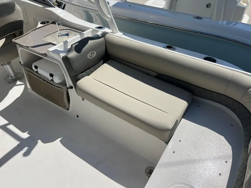 Slide: The Image of 2025 Key West 239 DFS boat interior with beige seating and storage compartments. - 35