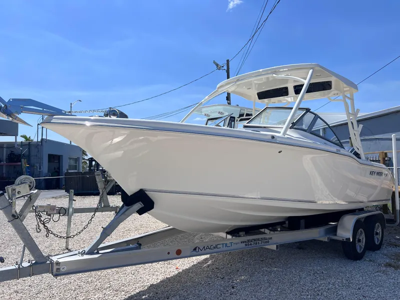 Slide: The Image of 2025 Key West 239 DFS boat on trailer, displayed outdoors under clear blue sky. - 5