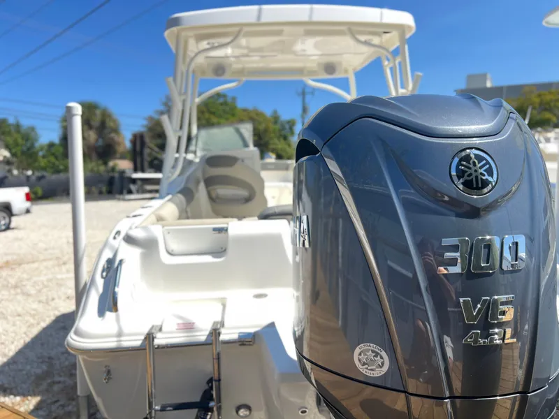 Slide: The Image of 2025 Key West 239 DFS boat with Yamaha 300 V6 engine, parked outdoors. - 8