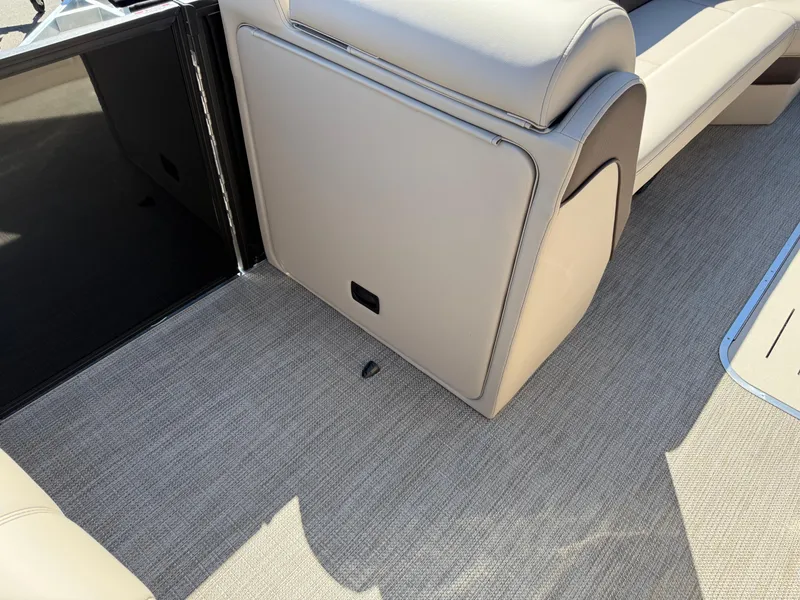 Slide: The Image of 2025 Bentley Pontoons Elite 253 Admiral interior with beige seating and carpet flooring. - 13