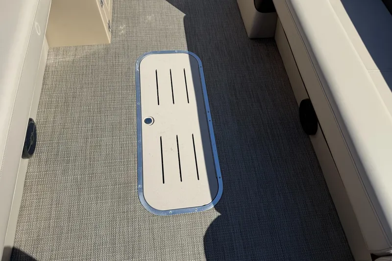 Slide: The Image of 2025 Bentley Pontoons Elite 253 Admiral interior flooring with storage compartment. - 16