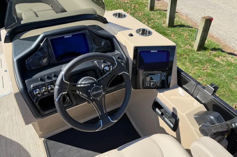 Slide: The Image of 2025 Bentley Pontoons Elite 253 Admiral dashboard with steering wheel and navigation screens. - 21