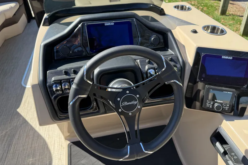 Slide: The Image of 2025 Bentley Pontoons Elite 253 Admiral dashboard with steering wheel and digital displays. - 23