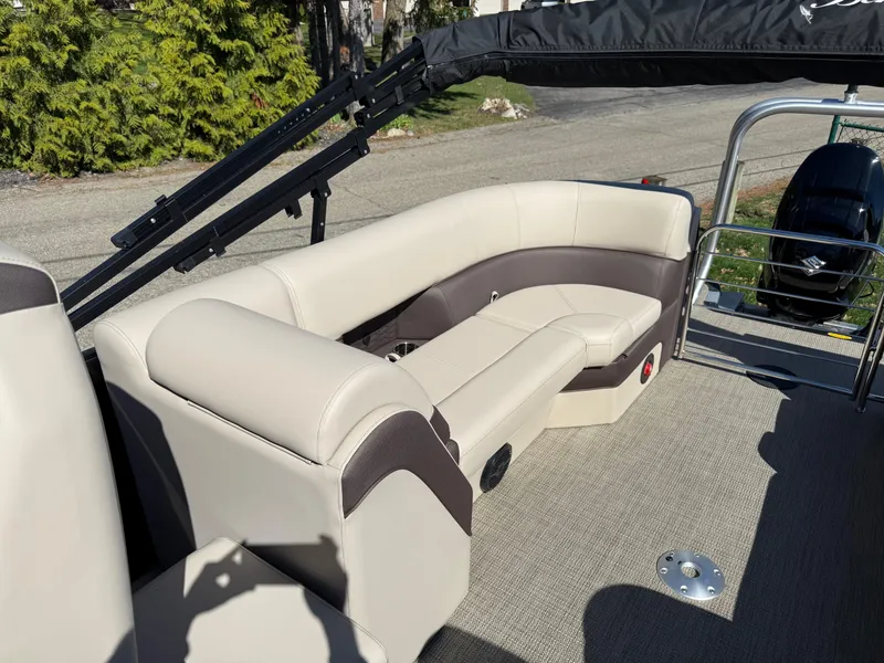 Slide: The Image of 2025 Bentley Pontoons Elite 253 Admiral interior with beige seating and modern design. - 26