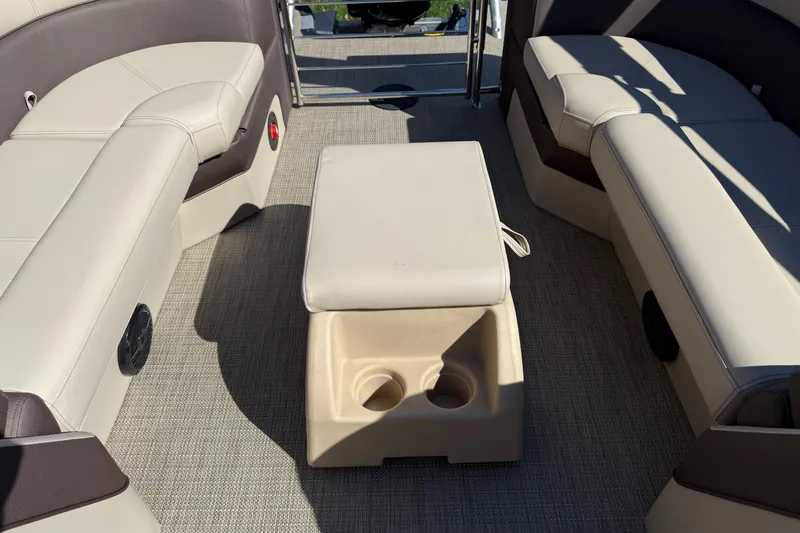 Slide: The Image of 2025 Bentley Pontoons Elite 253 Admiral interior with beige seating and central console. - 28