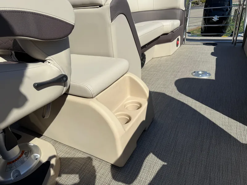Slide: The Image of 2025 Bentley Pontoons Elite 253 Admiral interior with beige seating and cup holders. - 31