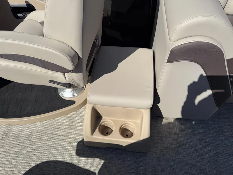 Slide: The Image of 2025 Bentley Pontoons Elite 253 Admiral interior with beige seating and cup holders. - 32