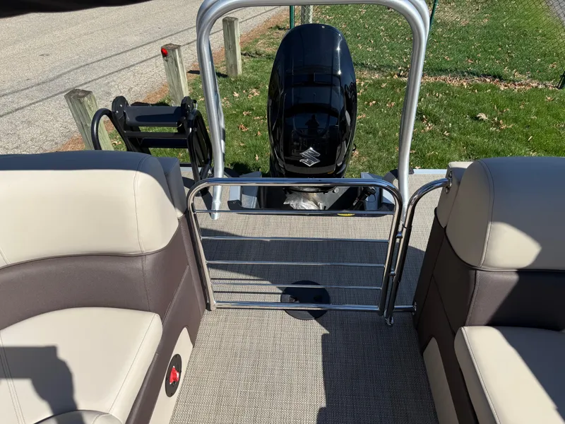 Slide: The Image of 2025 Bentley Pontoons Elite 253 Admiral interior with seating and outboard motor. - 35