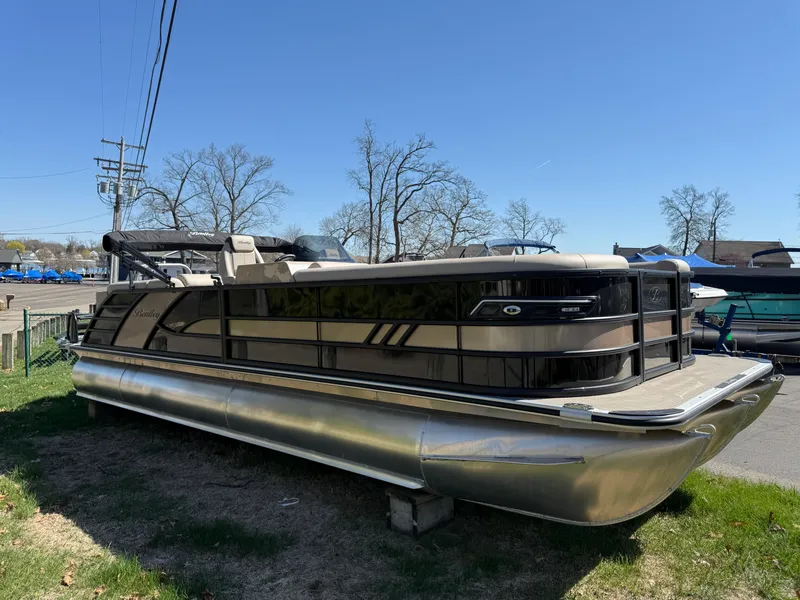 Slide: The Image of 2025 Bentley Pontoons Elite 253 Admiral on grass, showcasing sleek design and luxury features. - 5