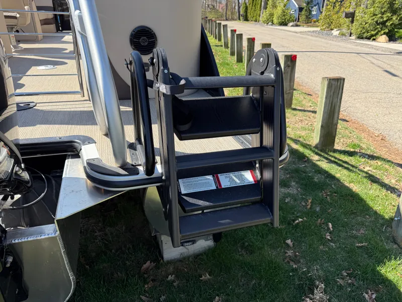 Slide: The Image of 2025 Bentley Pontoons Elite 253 Admiral with foldable boarding ladder on grass. - 8