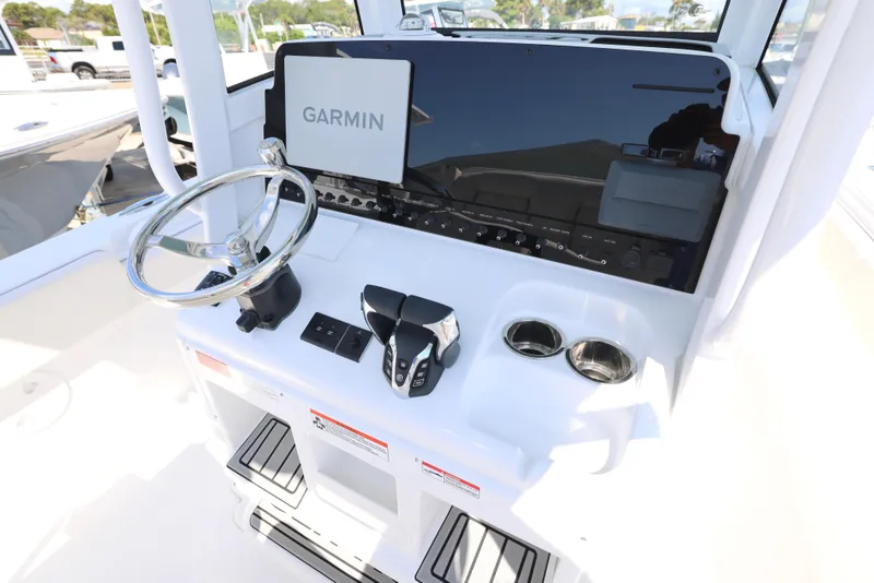 Slide: The Image of 2026 Sea Hunt Gamefish 27 Coffin Box boat interior with steering wheel and seating. - 11