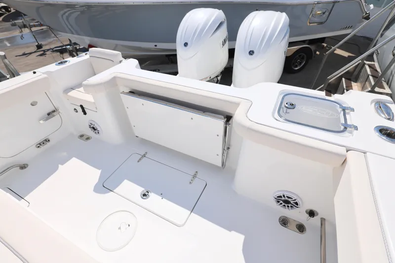Slide: The Image of 2026 Sea Hunt Gamefish 27 Coffin Box interior, featuring sleek white design and storage compartments. - 15