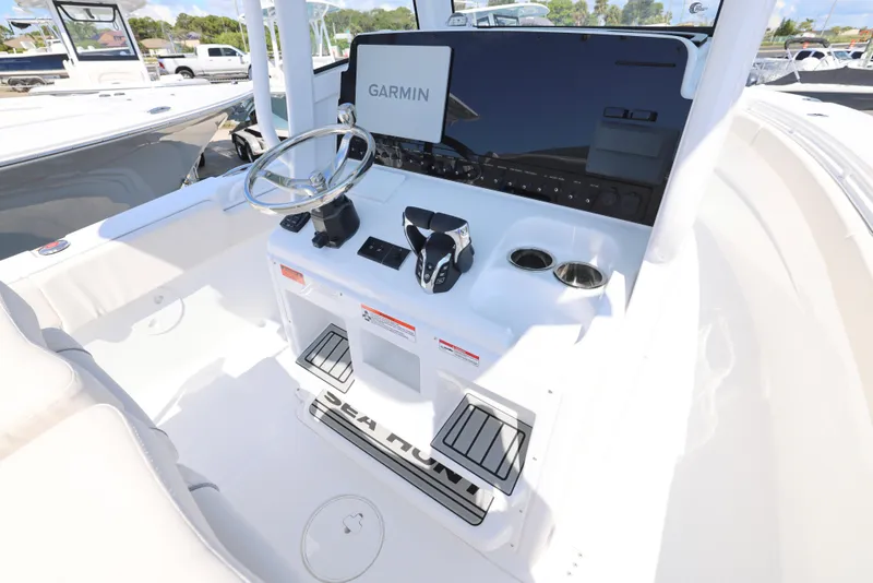Slide: The Image of 2026 Sea Hunt Gamefish 27 Coffin Box boat interior with Garmin equipment and sleek design. - 20
