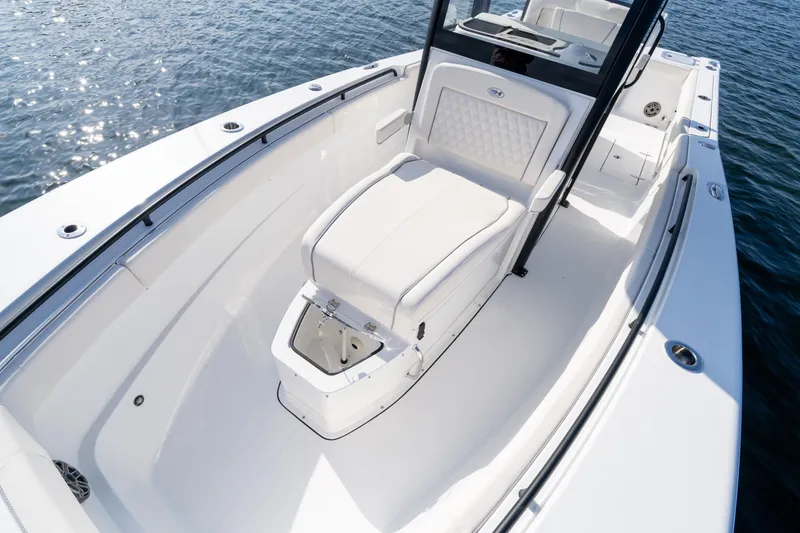 Slide: The Image of 2026 Sea Hunt Gamefish 27 Coffin Box boat interior with seating and storage on water. - 34