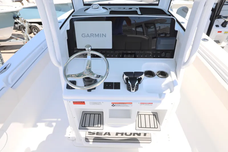Slide: The Image of 2026 Sea Hunt Gamefish 27 Coffin Box boat interior with seating and storage. - 5