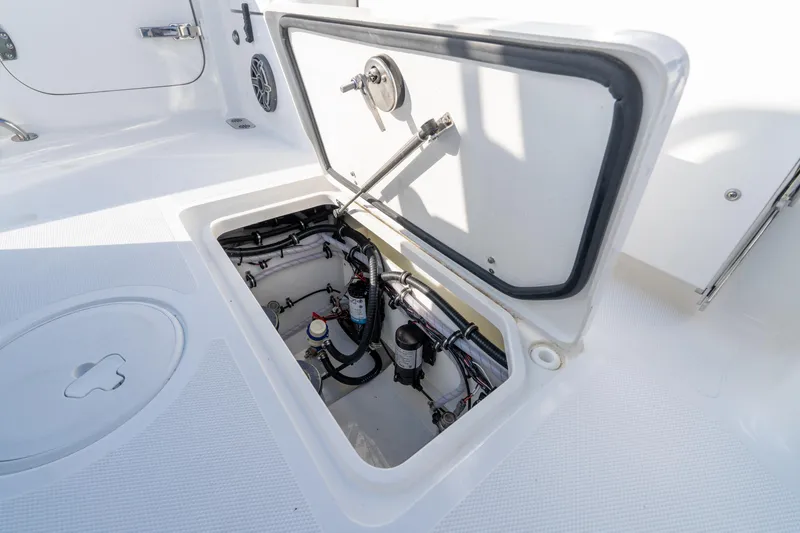 Slide: The Image of 2026 Sea Hunt Gamefish 27 Coffin Box boat interior on a serene lake. - 50