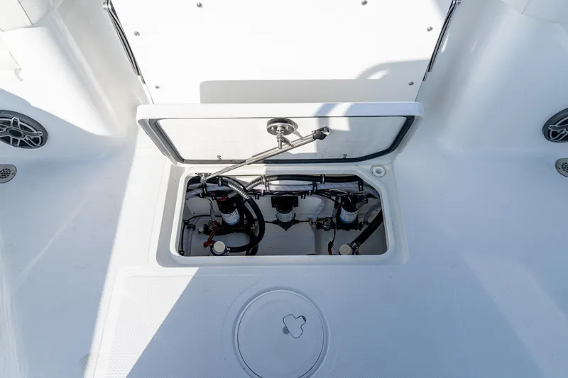 Slide: The Image of Open storage compartment on 2026 Sea Hunt Gamefish 27 Coffin Box boat, showing internal wiring and components. - 51