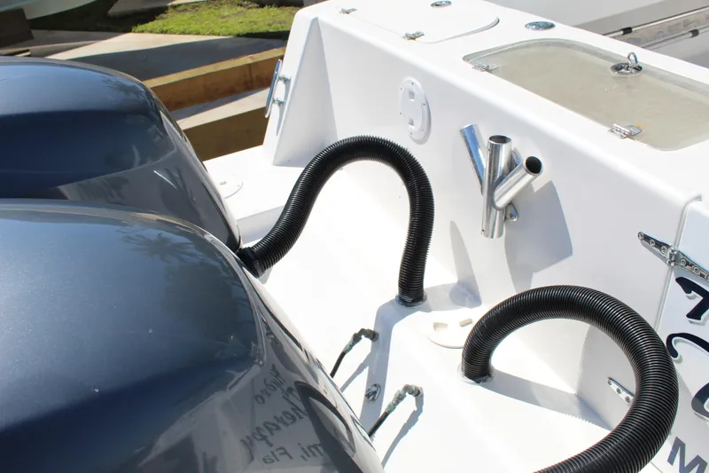 Slide: The Image of 2002 Contender 31 CC boat with dual engines and fishing rod holders. - 19