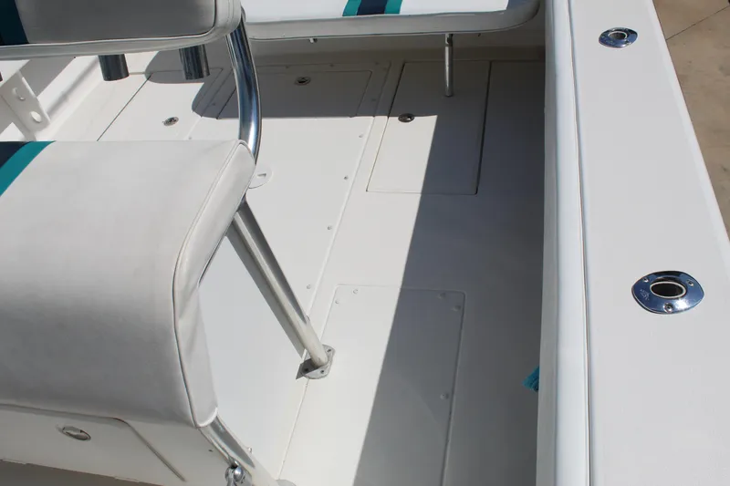 Slide: The Image of 2002 Contender 31 CC boat interior with white seating and deck details. - 28