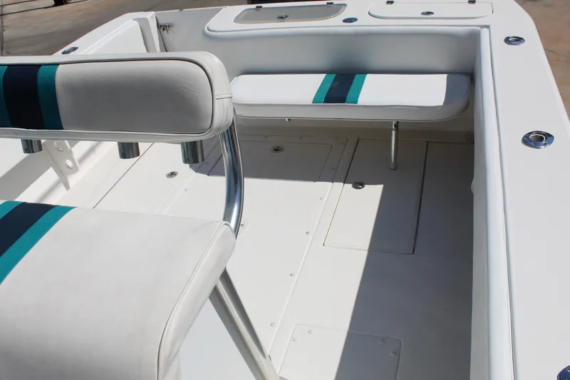 Slide: The Image of 2002 Contender 31 CC boat interior with white seating and teal accents. - 29