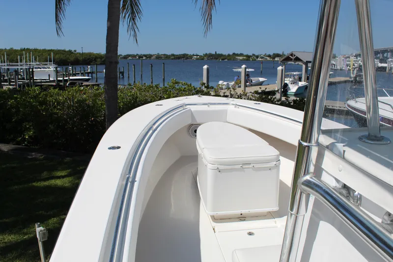 Slide: The Image of 2002 Contender 31 CC boat docked by a scenic waterfront with clear skies. - 31