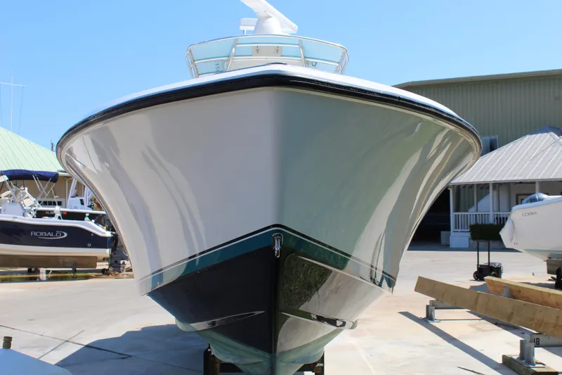 Slide: The Image of 2002 Contender 31 CC boat on display at a marina. - 34