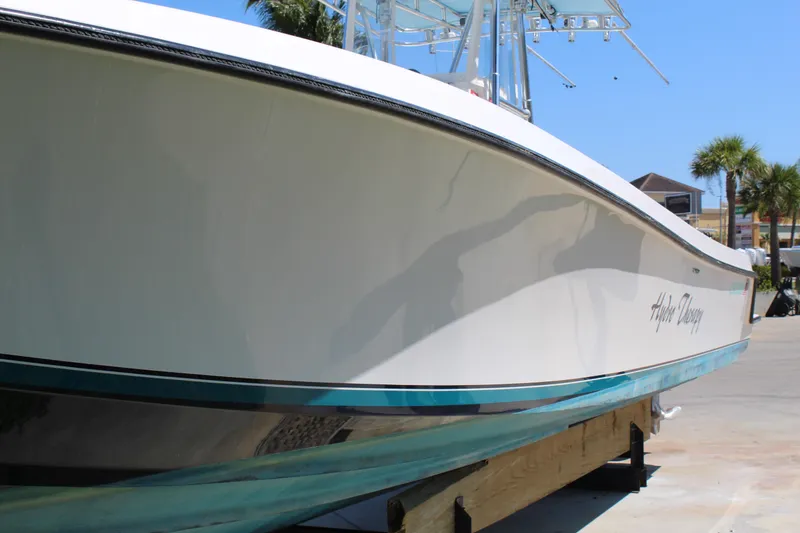 Slide: The Image of 2002 Contender 31 CC boat on display, sleek white hull, outdoor setting. - 39