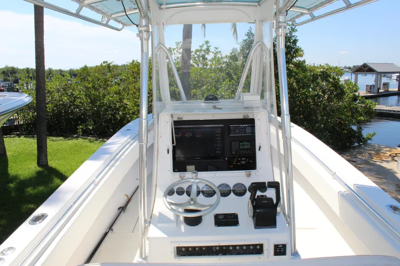 Slide: The Image of 2002 Contender 31 CC boat console with steering wheel and navigation equipment. - 42