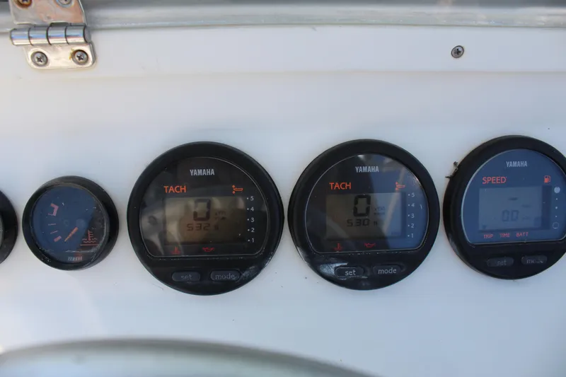Slide: The Image of Yamaha gauges on a 2002 Contender 31 CC boat dashboard. - 44