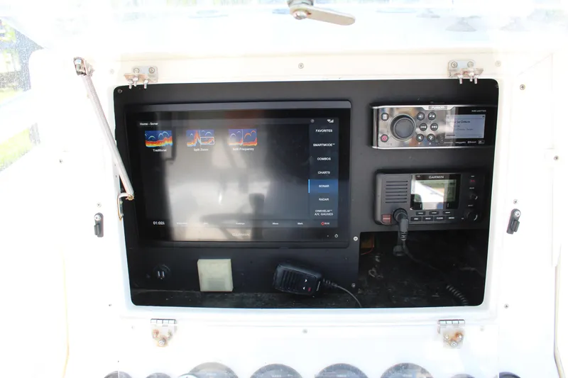 Slide: The Image of 2002 Contender 31 CC boat dashboard with navigation and communication equipment. - 45